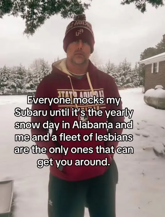 A man in a maroon hoodie and beanie stands in a snowy yard, looking at the camera with a serious expression. The overlaid…