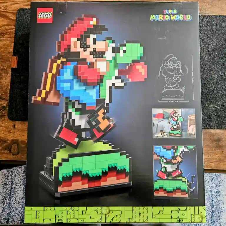 The image shows a LEGO product box for a Super Mario World set, featuring a pixelated Mario figure made of LEGO bricks…