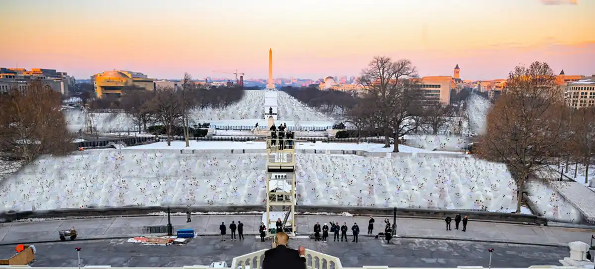 A wide-angle photo shows a person in a suit standing on a balcony overlooking a vast, snow-covered landscape. The ground is…