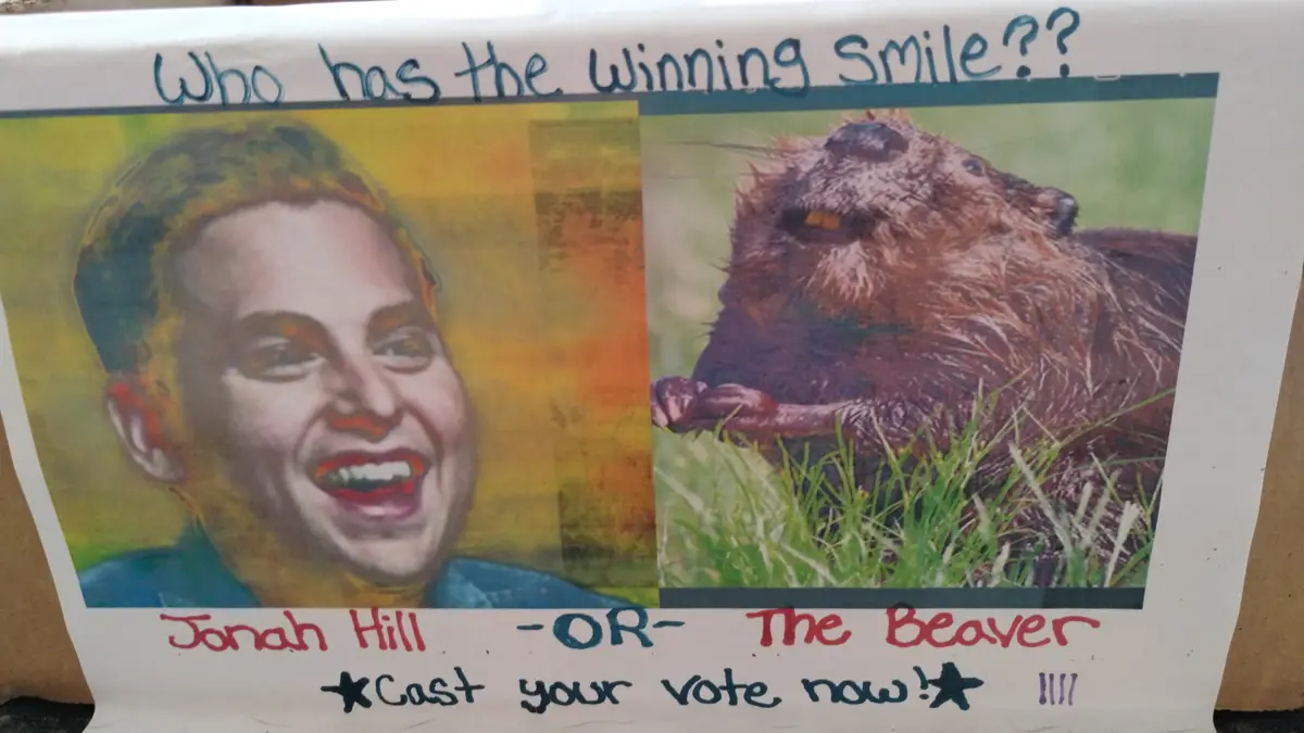A hand-drawn poster features a split image: on the left, a stylized portrait of Jonah Hill smiling broadly, and on the…