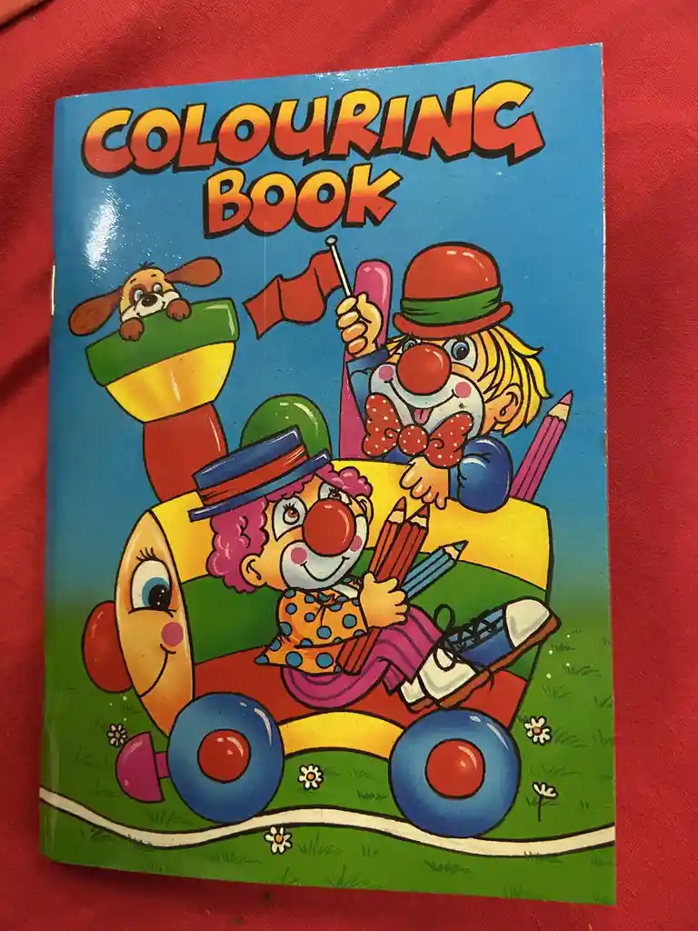 A brightly colored children's coloring book cover shows two clowns in a cartoon car, one driving and one waving a flag, with…