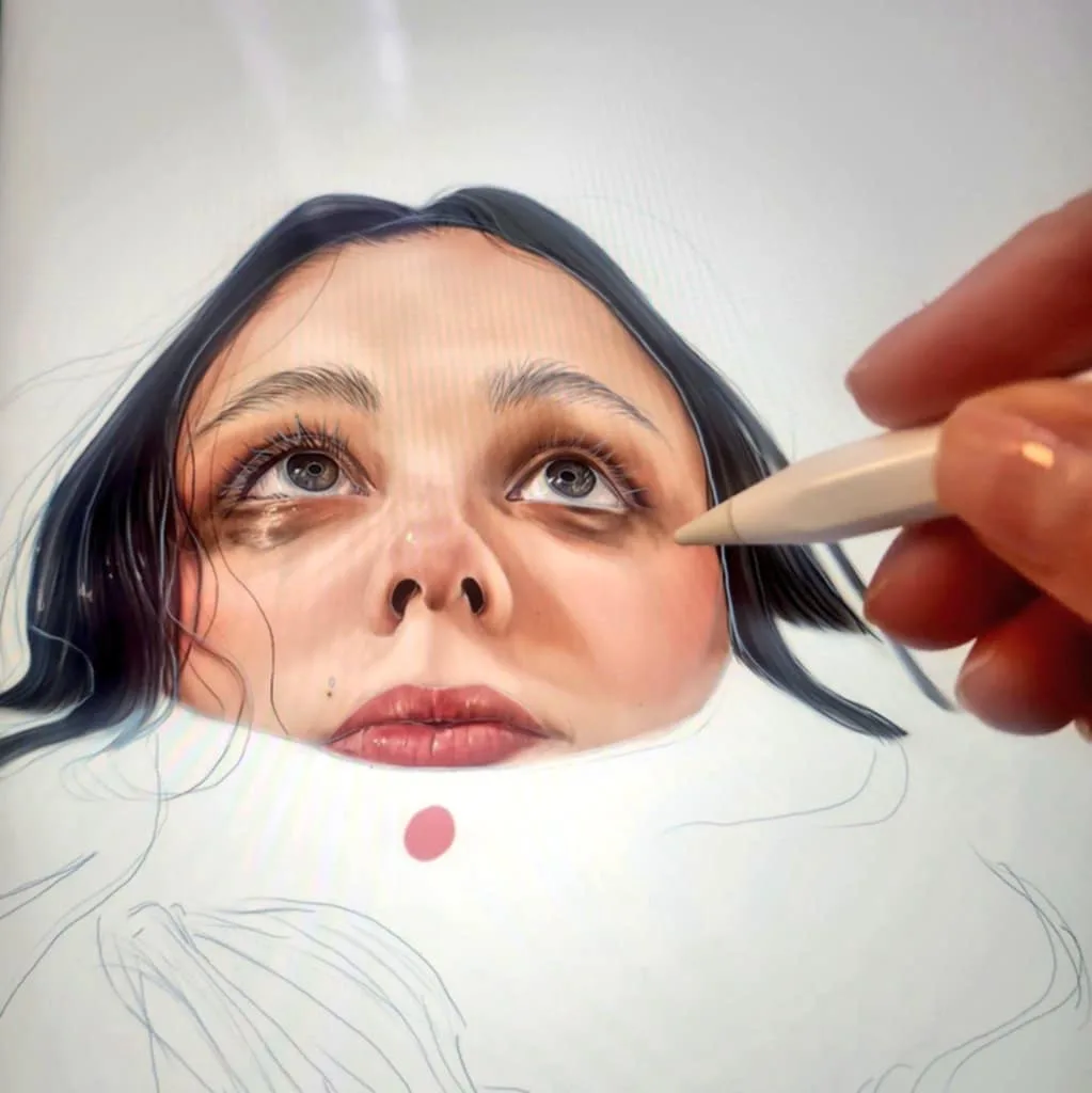 A close-up photo shows a hand holding a stylus, digitally painting a highly detailed, realistic portrait of a woman's face…
