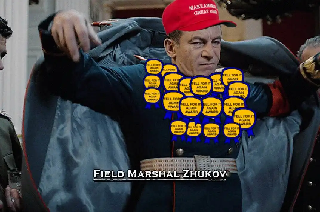 A man in a military uniform with a red 'MAKE AMERICA GREAT AGAIN' cap has numerous yellow 'FELL FOR IT AGAIN AWARD' badges…