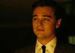 six sequential frames show Leonardo DiCaprio in a dimly lit scene, wearing a suit and tie, with his facial expression subtly…