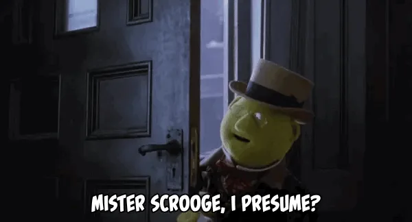 The image shows a yellow puppet character wearing a top hat and bow tie, standing in front of a dark wooden door. The…