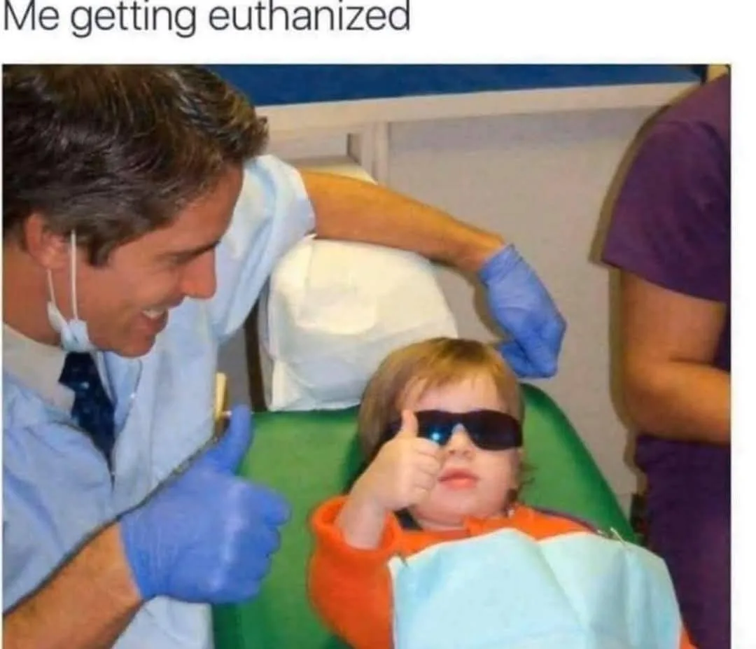 A young child wearing dark sunglasses sits in a green dental chair, giving a thumbs-up gesture. A smiling dentist in a light…