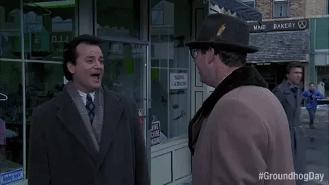 A split-screen image from the movie 'Groundhog Day' shows Phil Connors (Bill Murray) in a street scene. In the top row, he…