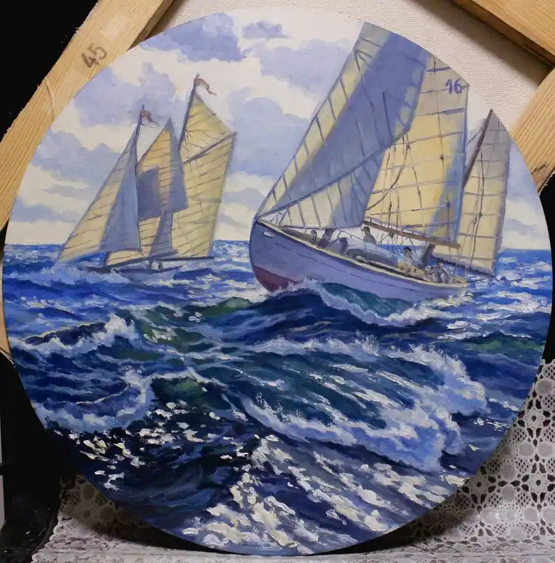 A circular painting depicts two sailboats racing on choppy blue waters under a cloudy sky; the boat on the right, marked…