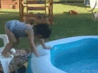 A child in a striped swimsuit attempts to climb into a small inflatable pool, then dramatically falls backward into the…