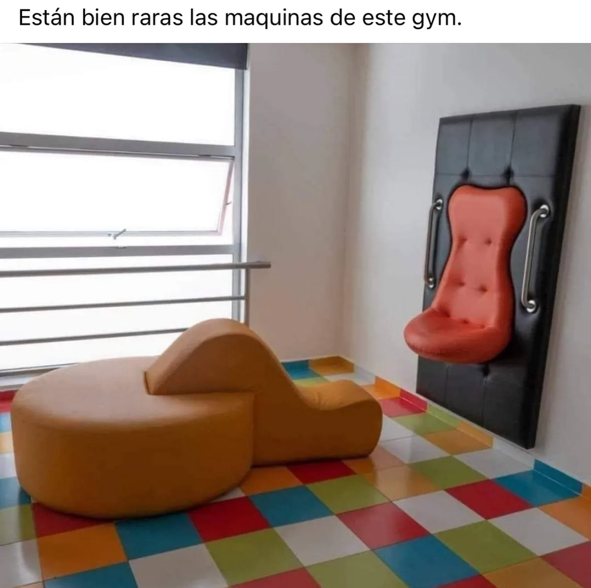 A gym room features two bizarre, childlike exercise machines: one is a tan, cloud-shaped lounge chair on a colorful…
