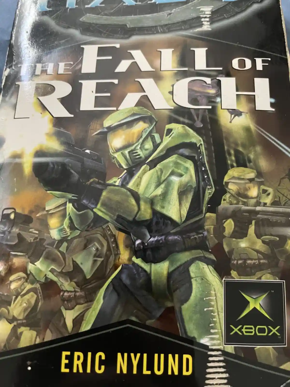 The image shows the cover of a book titled 'The Fall of Reach' by Eric Nylund, featuring artwork of soldiers in green armor…