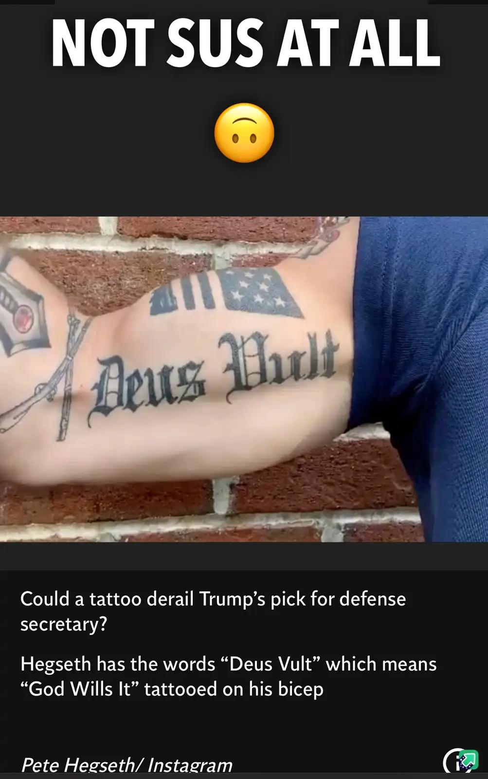 The image shows a person's bicep with tattoos including an American flag and the Latin phrase 'Deus Vult' in gothic script…