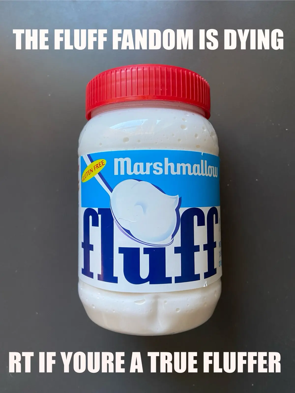 A jar of Marshmallow Fluff with a red lid sits on a dark surface. The label clearly shows the brand name 'Marshmallow Fluff'…