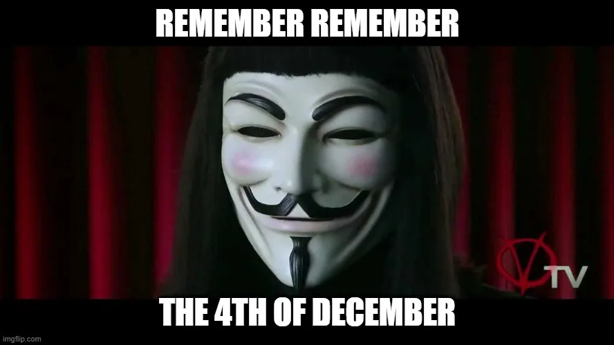 A person wearing a white Guy Fawkes mask with a wide grin and rosy cheeks, set against a dark red curtain backdrop. The…