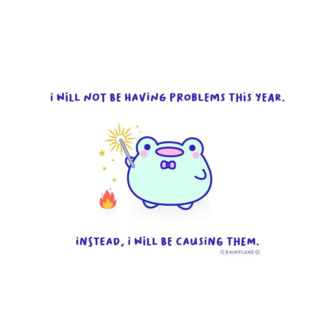 A light blue cartoon frog wearing a bowtie holds a magic wand that sparks, but a small fire burns on the ground beside it…