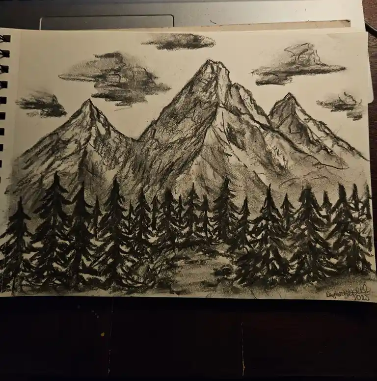 A charcoal sketch on paper shows a mountain range with jagged peaks and a foreground of pine trees, with clouds in the sky…