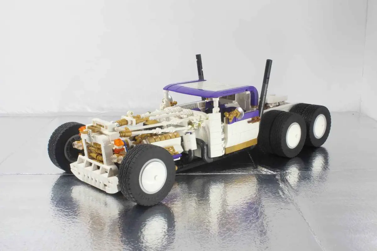 A detailed Lego model of a custom truck with a white body, purple roof, and exposed engine components made of gold and white…