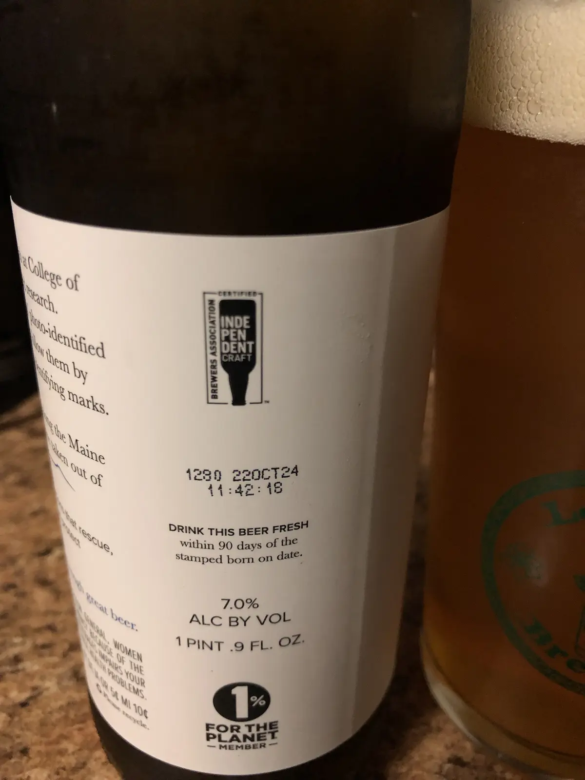 A close-up photo of a beer bottle label showing a stamped 'born on' date of 22OCT24, with text instructing to 'DRINK THIS…