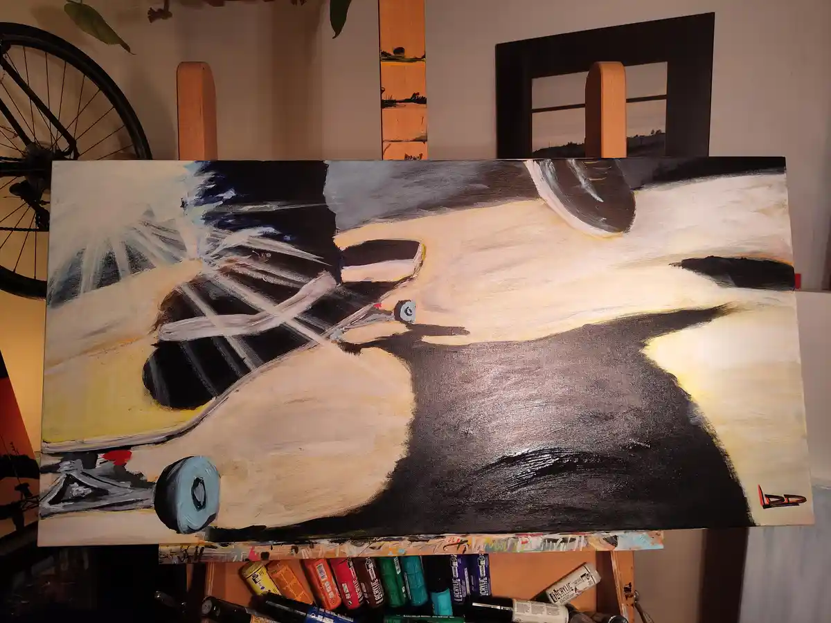 A painting on an easel depicts a stylized, abstract bicycle with thick brushstrokes in black, white, and beige, signed 'DD'…