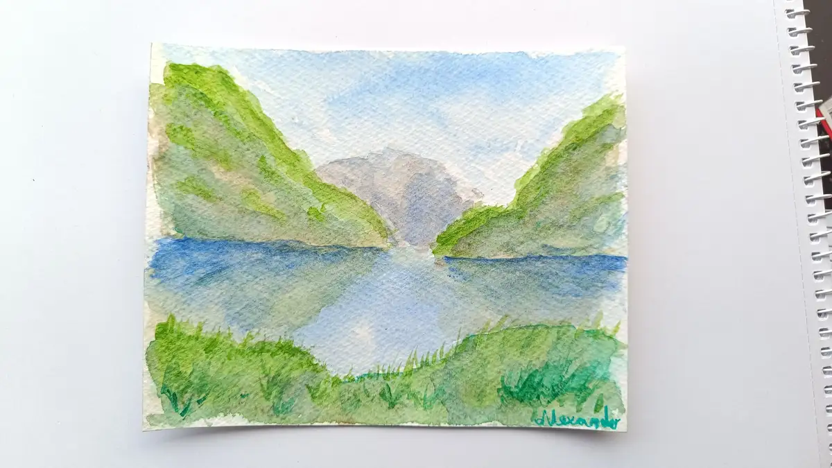 A watercolor painting on textured paper depicts a serene landscape with green hills flanking a blue lake under a light blue…