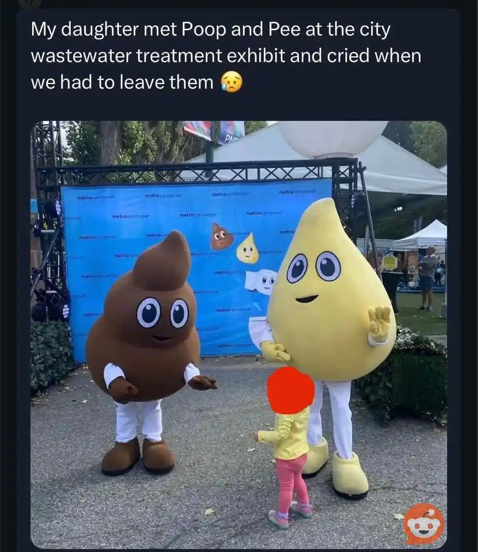 A young child in a yellow jacket and pink pants stands between two large, friendly-looking mascot characters: one shaped…