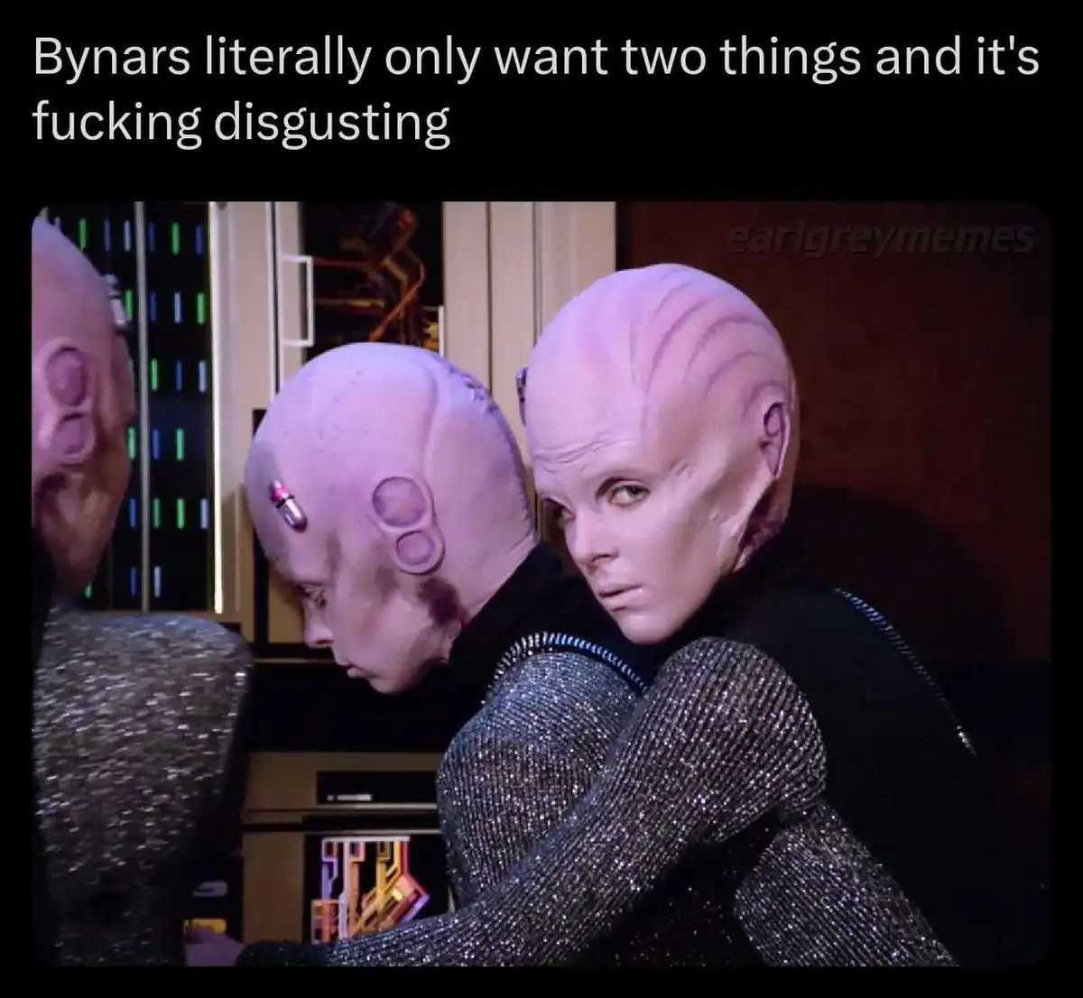 The image shows two Bynars from Star Trek, one looking over its shoulder with a disgusted expression while the other is…