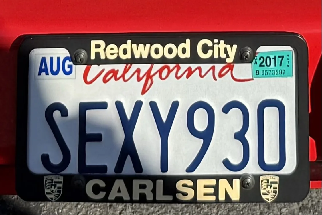 A close-up of a California license plate reading 'SEXY930' with 'Redwood City' and 'California' printed above, and 'CARLSEN'…
