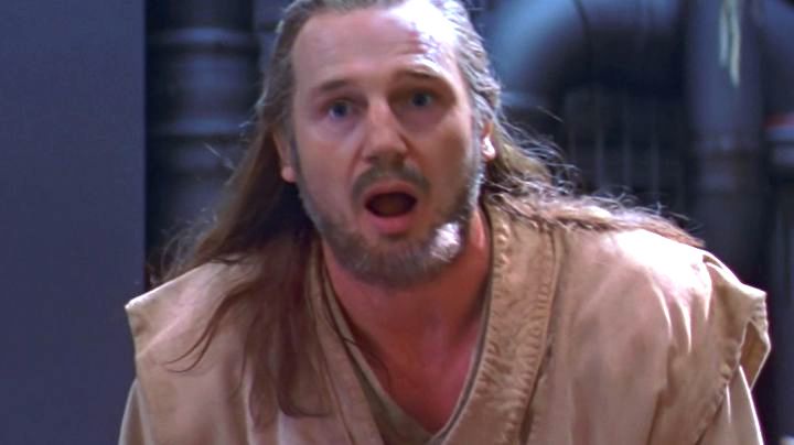 a man with long hair and a beard, wearing a tan tunic, stares with wide eyes and an open mouth in a scene from 'The Princess…