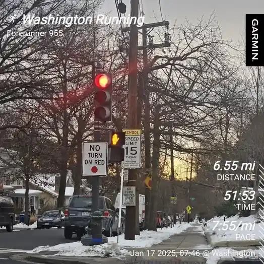 A screenshot from a Garmin Forerunner 955 running watch shows a runner's stats overlaid on a photo of a red traffic light…