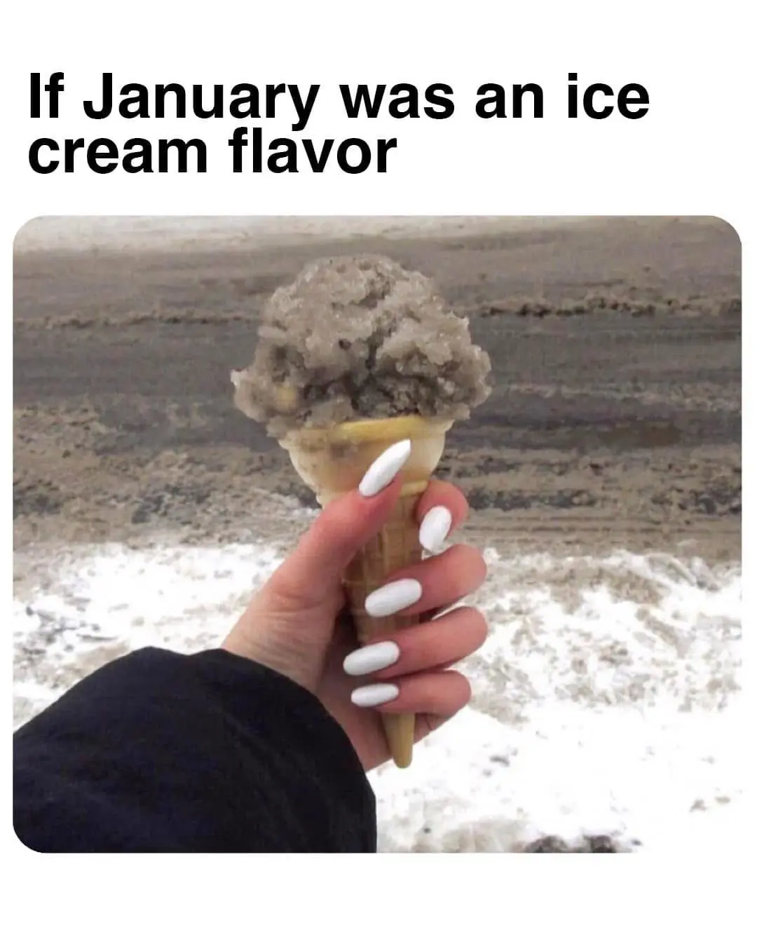 A hand with white manicured nails holds an ice cream cone with a scoop that looks like dirty, gritty sand. The background…
