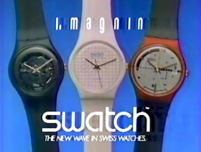 Three colorful Swatch watches are displayed side-by-side against a blue background. The text 'i. magnin' appears above the…