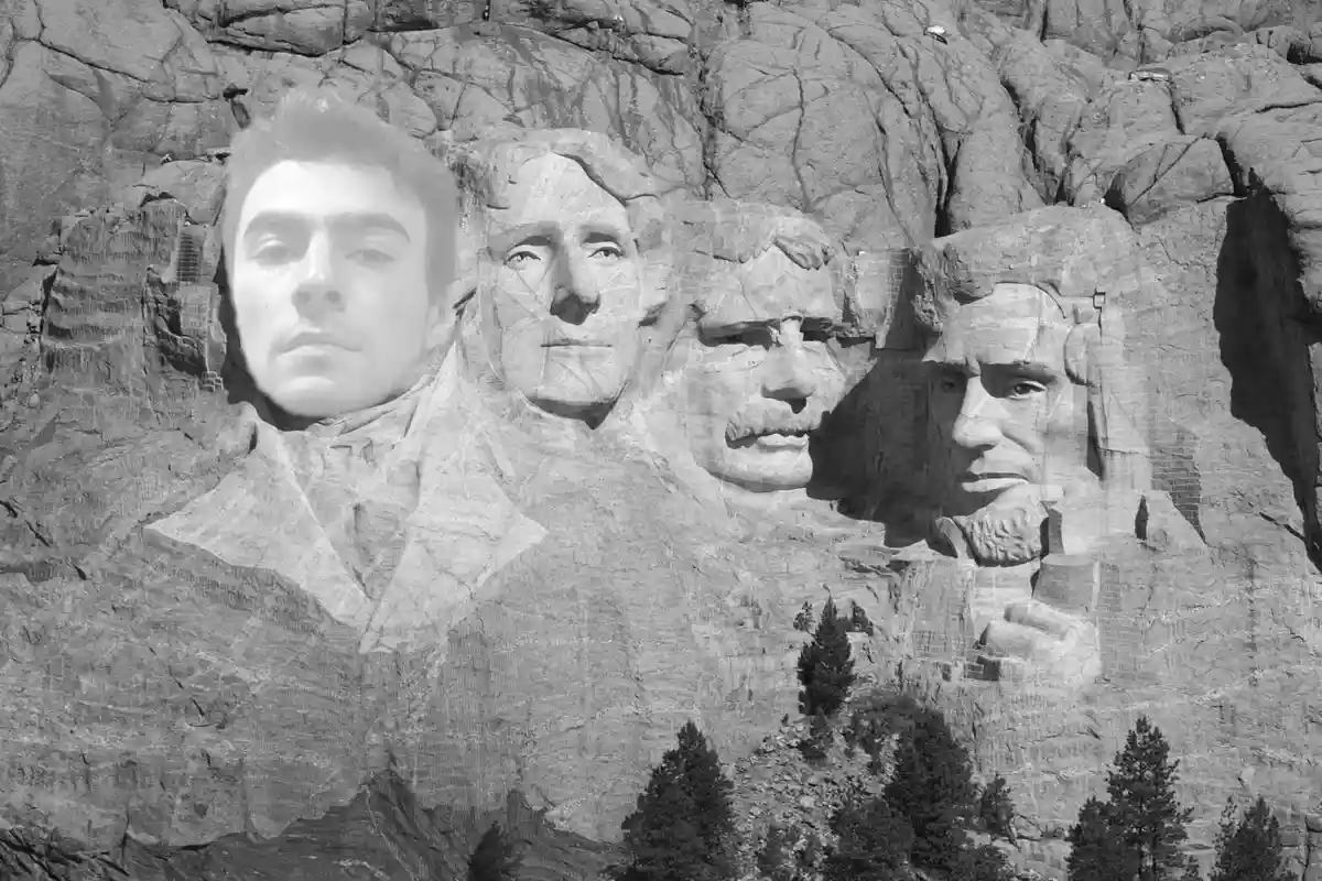 A black-and-white image of Mount Rushmore, where the face of a young man is digitally superimposed over the leftmost carved…