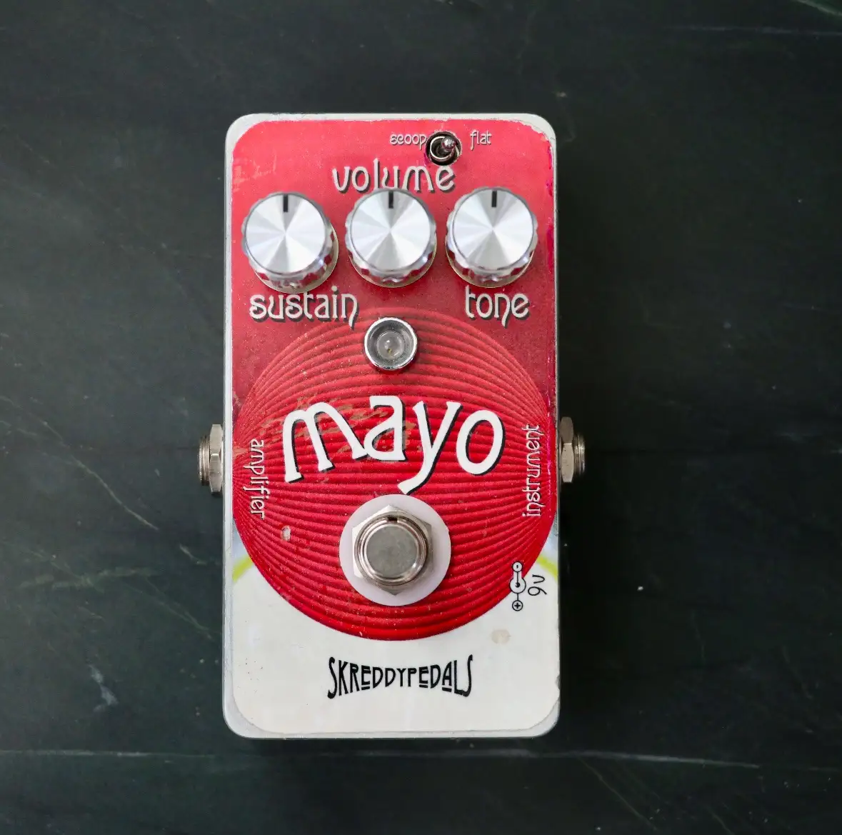 A red and white guitar effects pedal labeled 'mayo' with knobs for 'volume', 'sustain', and 'tone', and the brand…