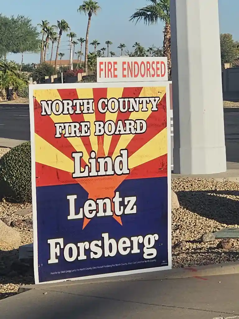 A political campaign sign for the North County Fire Board features three candidate names—Lind, Lentz, and Forsberg—stacked…