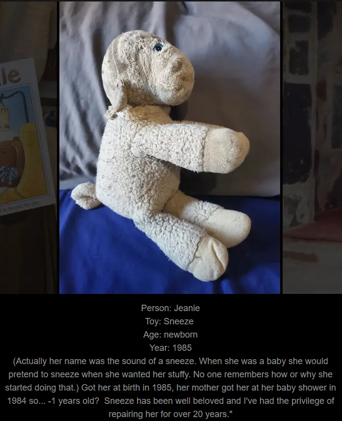 A worn, beige stuffed lamb toy sits on a blue fabric surface, with a black text box at the bottom containing a personal…