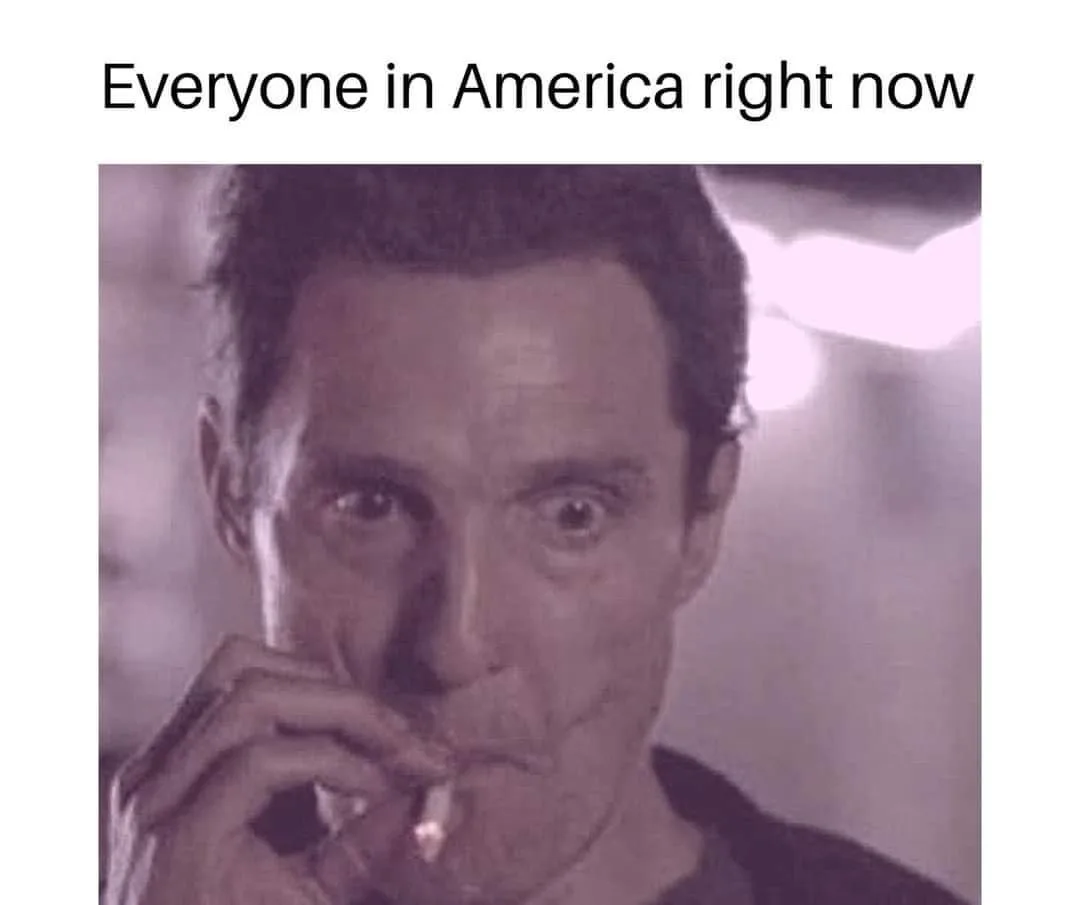 A close-up image of a man with wide, startled eyes, holding a lit cigarette to his lips. The image has a purple tint and is…