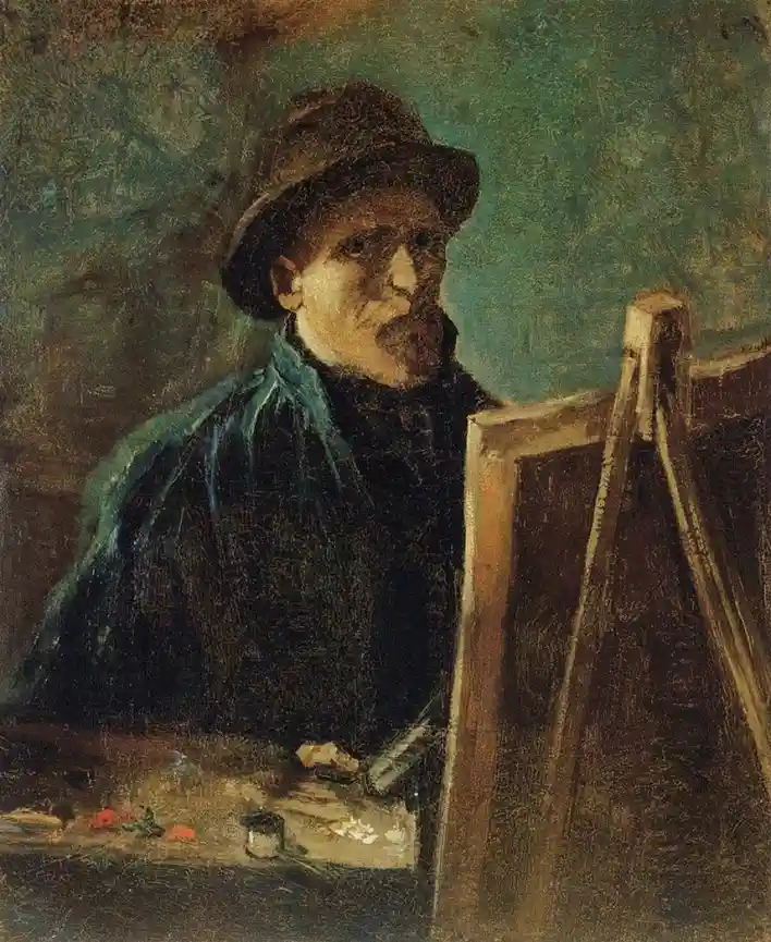 A painting of Vincent van Gogh, wearing a hat and dark coat, seated before an easel with a palette of paint on a table. The…