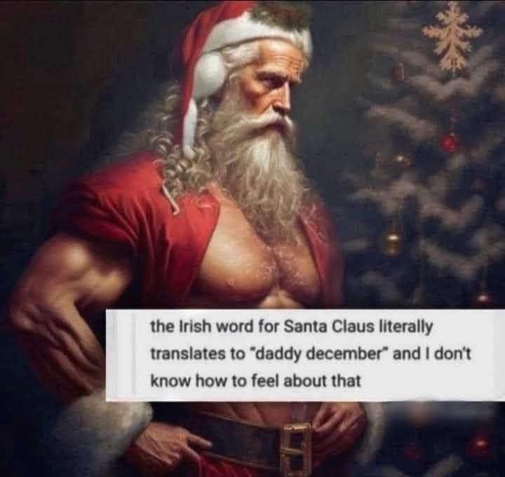 A muscular, shirtless Santa Claus with a red hat and beard stands in front of a decorated Christmas tree. A white text box…