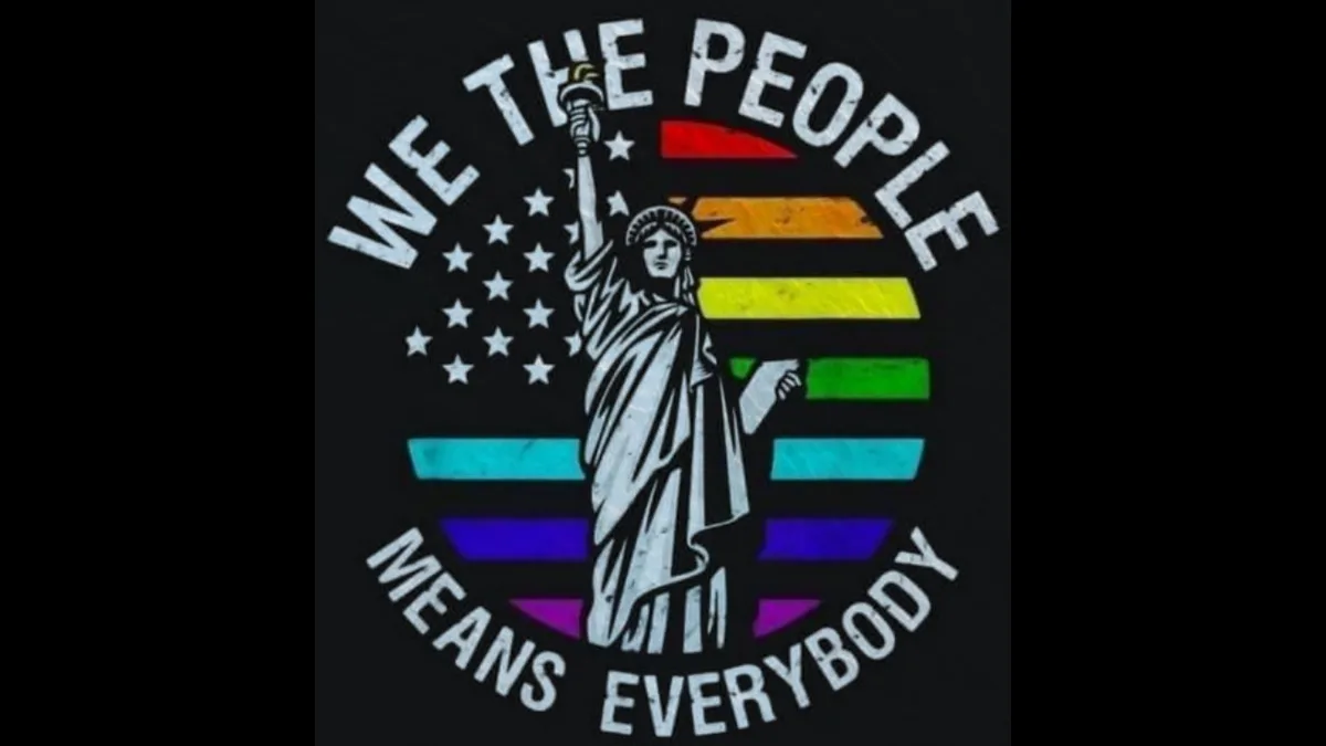 A black t-shirt graphic shows a white silhouette of the Statue of Liberty holding her torch, set against a rainbow-striped…