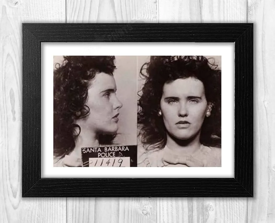 A framed black-and-white mugshot of a woman with curly hair, showing profile and frontal views, with 'SANTA BARBARA POLICE…