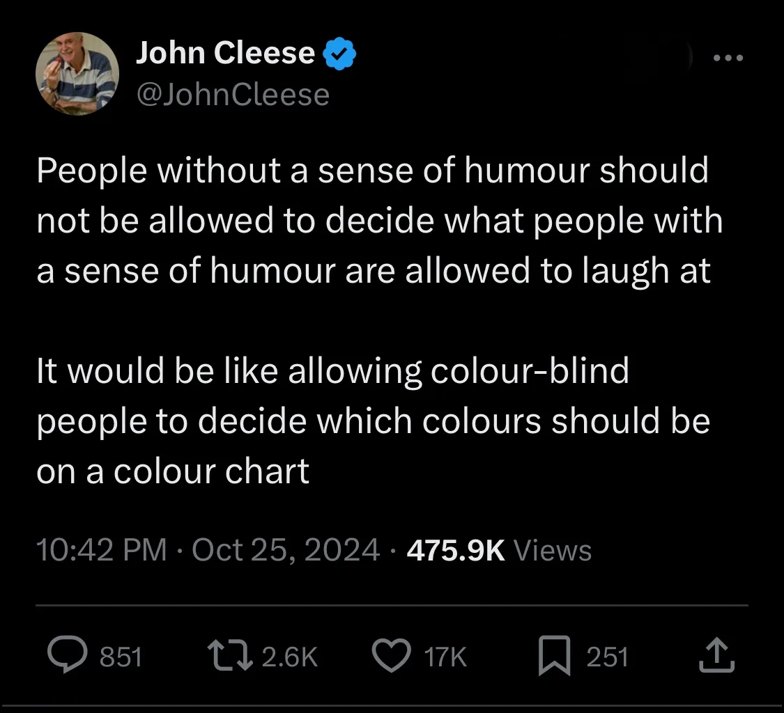 A screenshot of a tweet by John Cleese, who is shown in his profile picture holding a red object. The tweet text is overlaid…