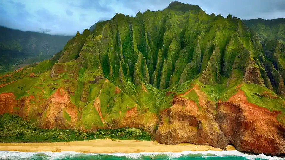 The NÃÂ Pali Coast presents a primordial wonderland, its sharp crags and canyons softened by lush green vegetation. Shaped…