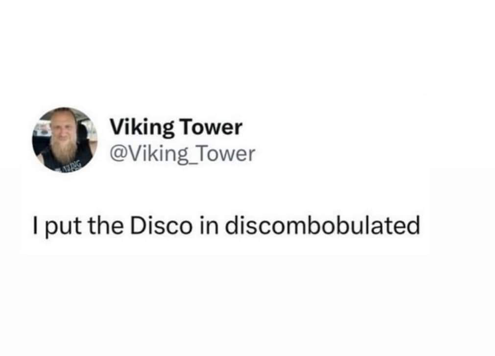 A screenshot of a tweet from user 'Viking Tower' (@Viking_Tower) showing a man with a long beard in a car. The tweet text…