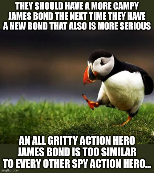 A penguin stands on grass, looking down with a slightly confused or unimpressed expression. The text overlaid on the image…