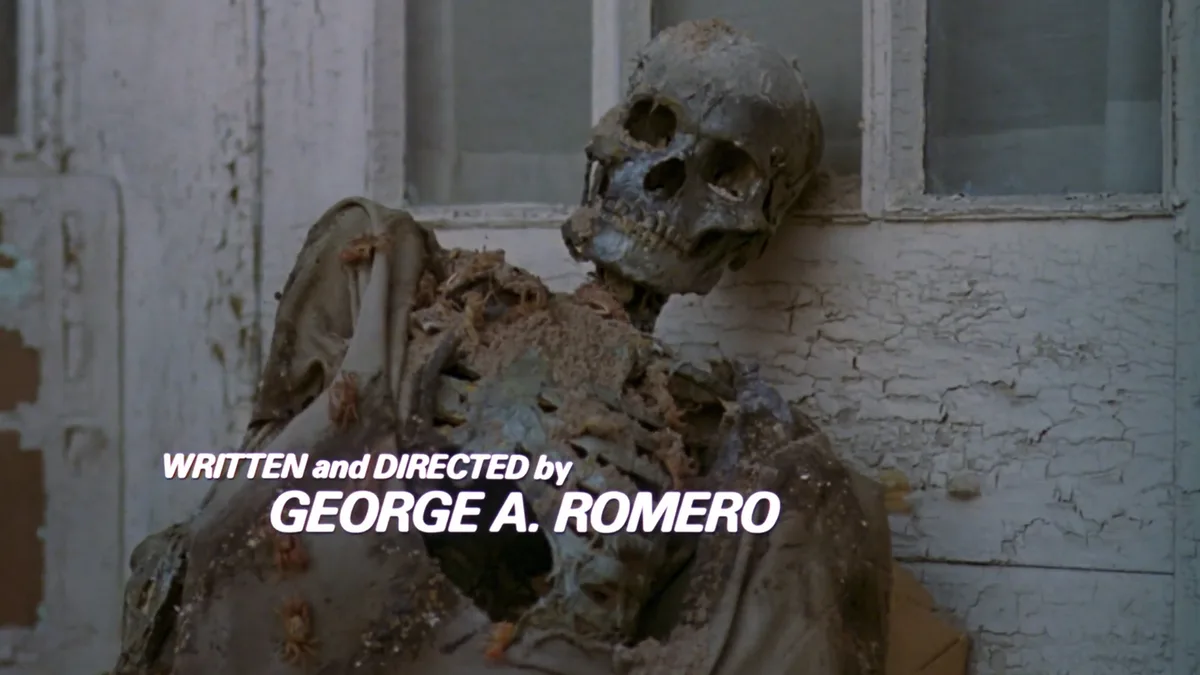 A decaying zombie skeleton leans against a weathered, peeling white wall near a window, with credits text overlaid. The text…