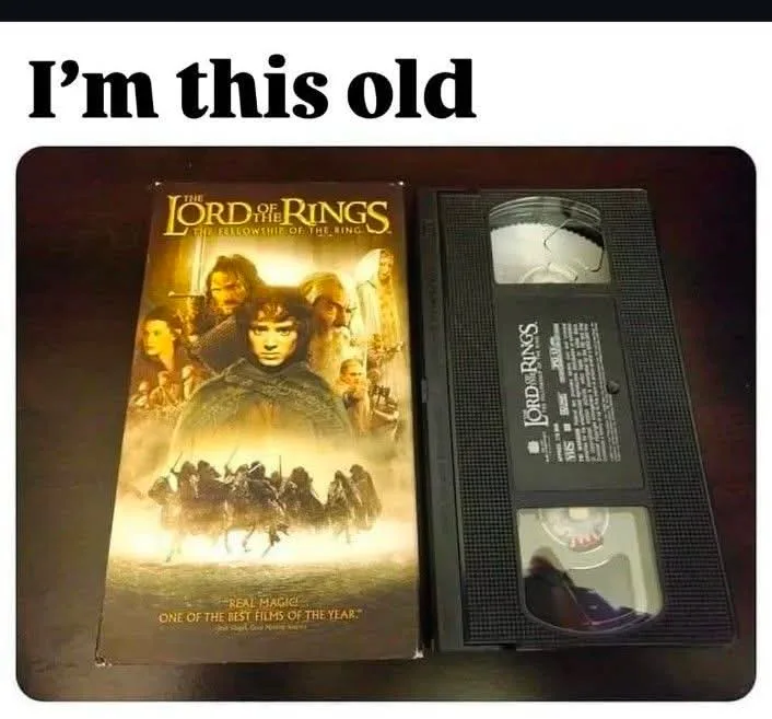 A VHS tape and its case for 'The Lord of the Rings: The Fellowship of the Ring' are shown side by side on a dark surface…