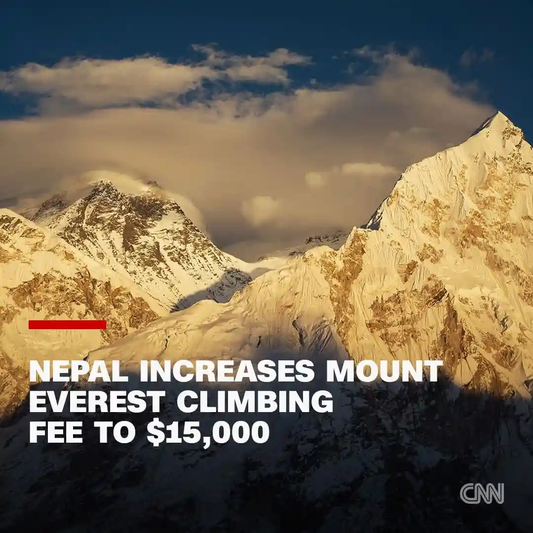 A scenic photo of snow-capped mountains, likely Mount Everest, under a partly cloudy sky with golden sunlight. Overlaid in…