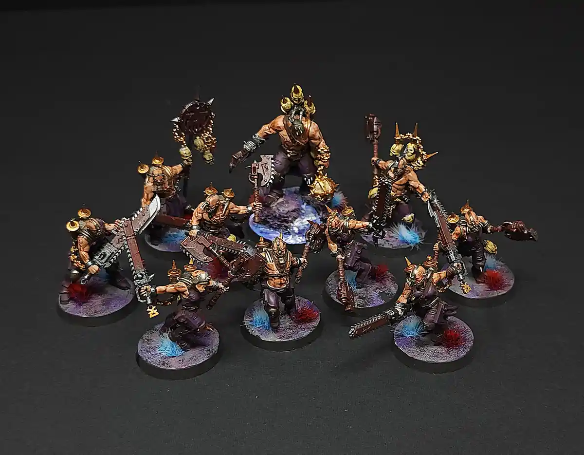 A group of intricately painted fantasy miniatures, resembling brutal warriors or orcs, are arranged in a circle around a…