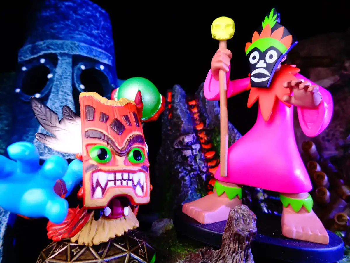 Three colorful figurines from the video game 'The Legend of Zelda: The Minish Cap' are posed together against a dark, rocky…