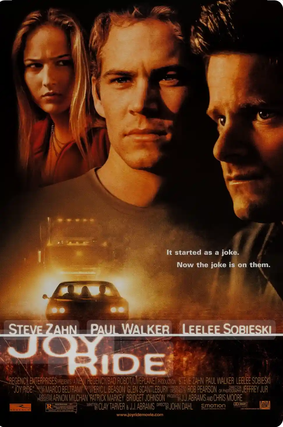 The image is a movie poster for 'Joy Ride' featuring three main actors: Steve Zahn, Paul Walker, and Leelee Sobieski. Their…